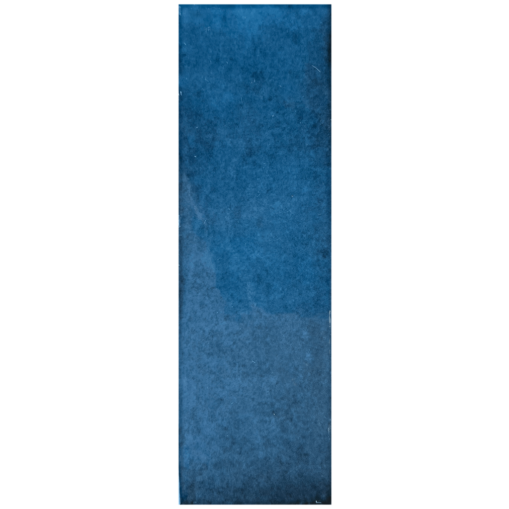 Candy 2x6" porcelain tile in a rich blue hue, featuring a glossy texture and vintage brick-inspired design.
