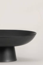 Matte black ceramic footed bowl, ideal for home decor and versatile for various contents like fruits and decorative items.