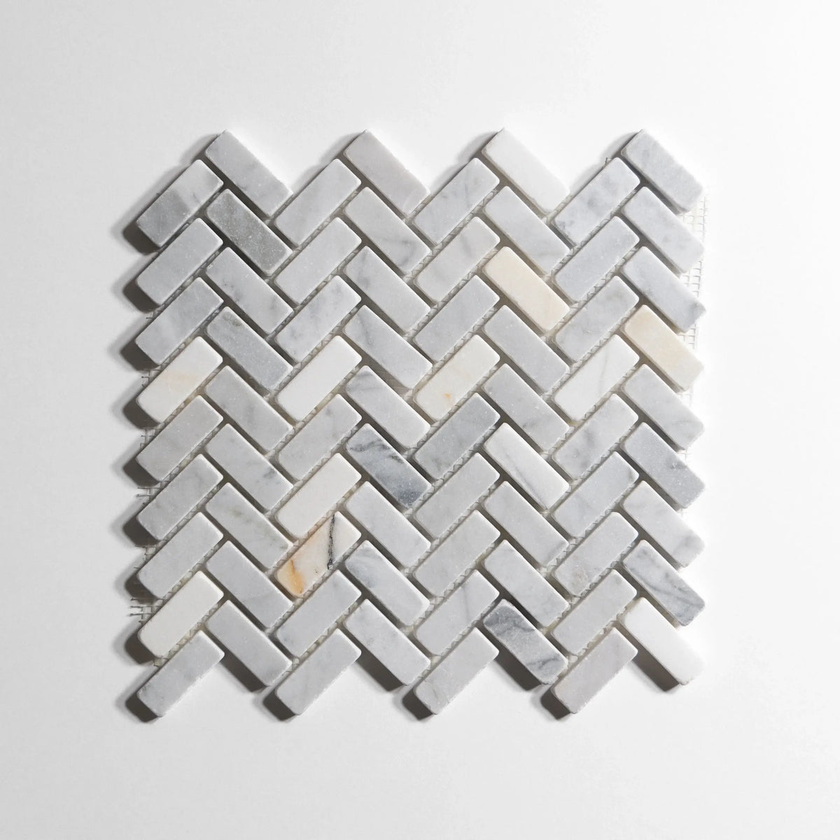 Antique Carrara marble tile, herringbone pattern, soft white-gray