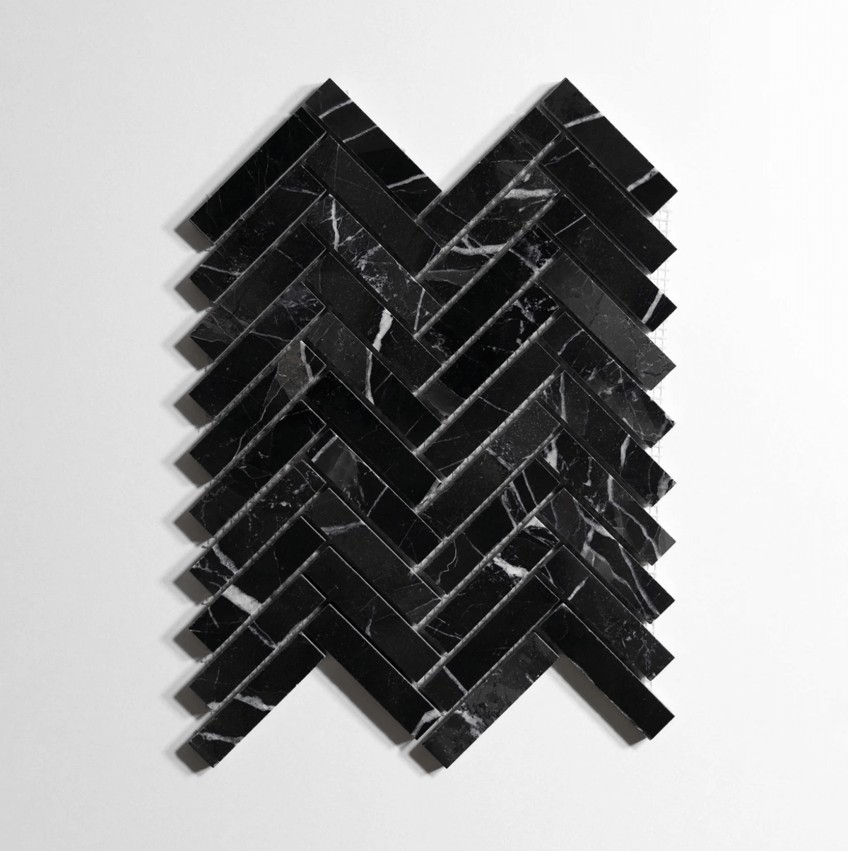 Nero St. Gabriel marble tile, herringbone pattern, black with white veining
