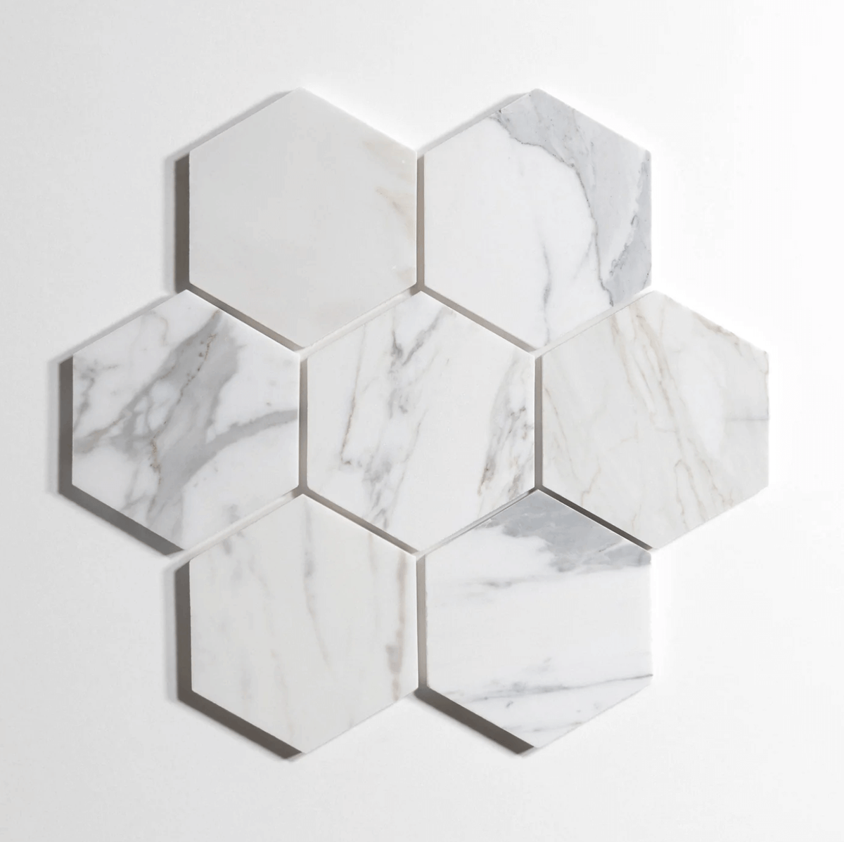 Calacatta marble tile, hexagon shape, white with dramatic gray veining, 5 inch