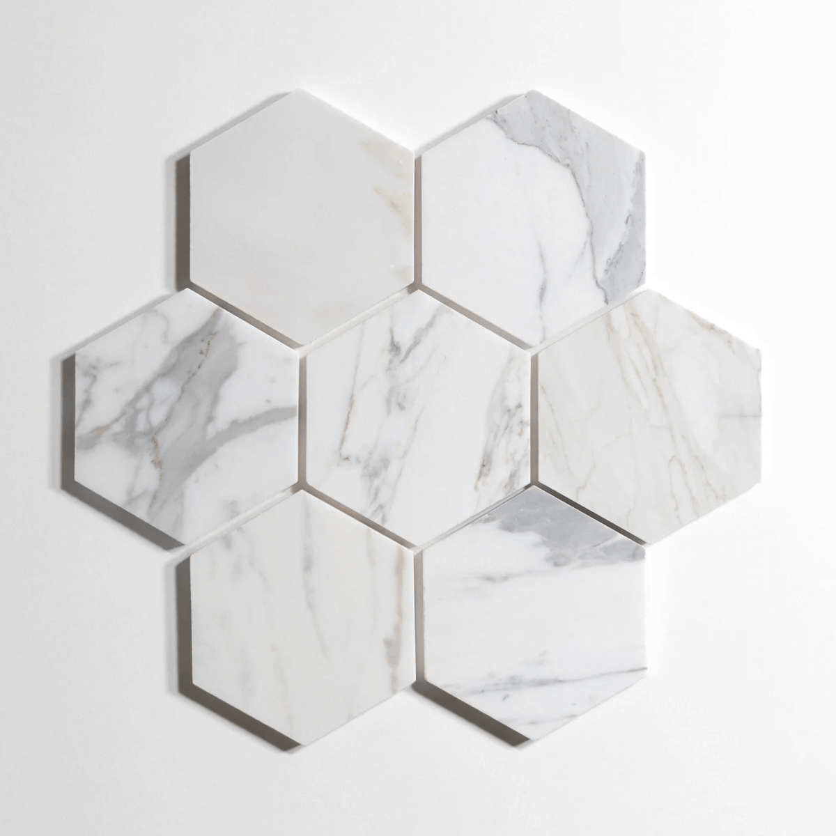 Calacatta marble tile, hexagon shape, white with dramatic gray veining, 5 inch