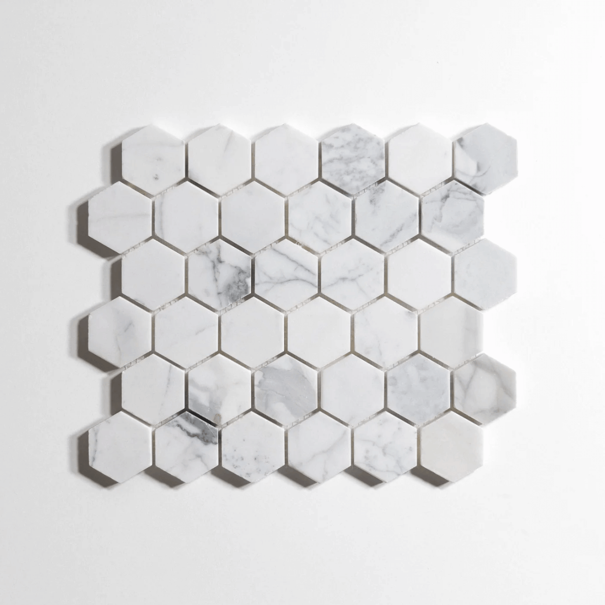 Polished 2" hexagon mosaic tiles in marble finish, 10 sheets per box, ideal for elegant home decor.