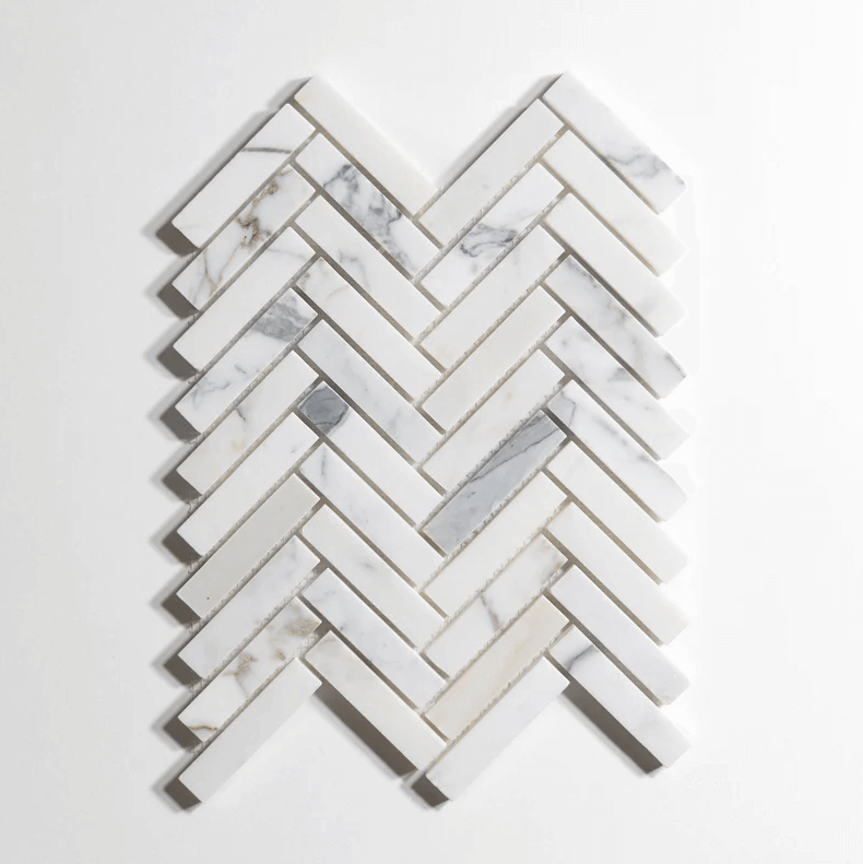 Calacatta marble tile, herringbone pattern, white with dramatic gray veining